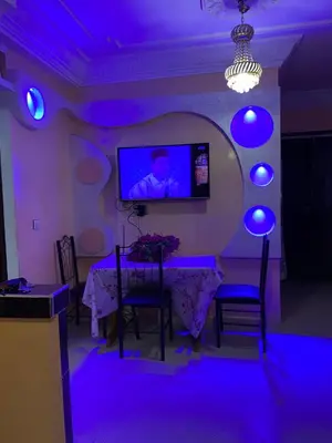 a room with a table with purple lights on it at Wafae in Meknès
