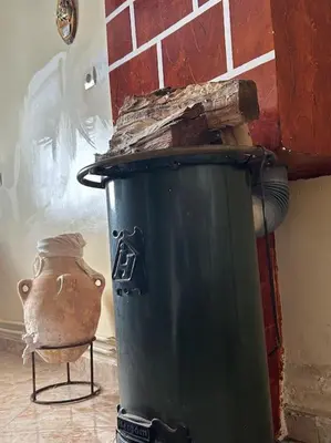 a green trash can sitting next to a brick wall at Zen environnement Horse riding in Zaouia dʼIfrane