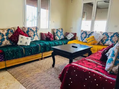 a living room with a couch and a coffee table at Zen environnement Horse riding in Zaouia dʼIfrane