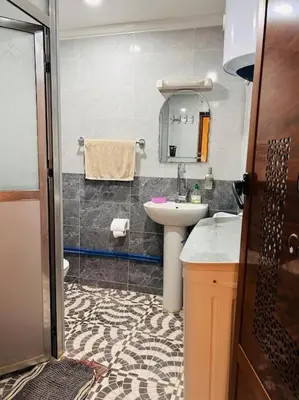 a bathroom with a sink and a mirror at Coquet F2 Jnane el Atlas Ifrane in Zaouia dʼIfrane
