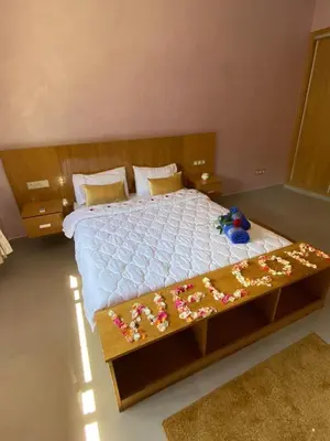 a bedroom with a bed with flowers on it at charmante villa de luxe à Marrakech in Marrakech
