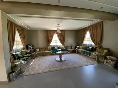 a living room with a couch and a table at charmante villa de luxe à Marrakech in Marrakech