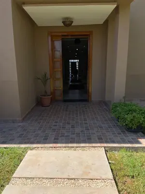 a hallway of a building with a door and plants at charmante villa de luxe à Marrakech in Marrakech