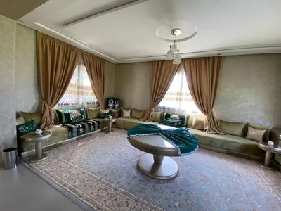 a living room with a couch and a table at charmante villa de luxe à Marrakech in Marrakech