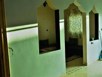 a mirror on the side of a wall in a room at Sahara Apartements in Merzouga
