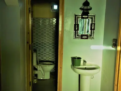 a bathroom with a sink and a toilet at Sahara Apartements in Merzouga