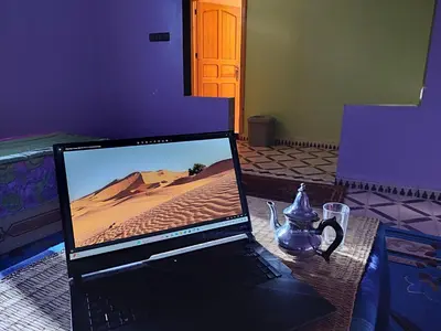 a laptop computer sitting on top of a table at Sahara Apartements in Merzouga
