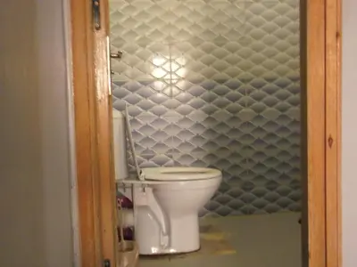 a bathroom with a white toilet in a room at Sahara Apartements in Merzouga