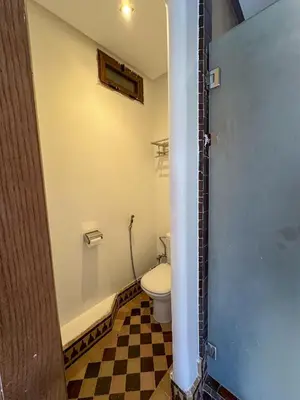 a bathroom with a toilet and a sink at Palais Volteras in Marrakech