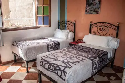 a room with two beds and a window at Hôtel Restaurant Ali in Midelt