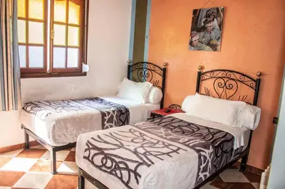 a room with two beds and a window at Hôtel Restaurant Ali in Midelt