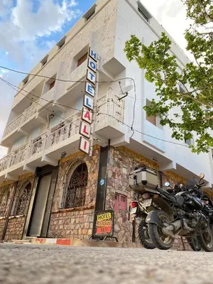 a motorcycle parked in front of a building at Hôtel Restaurant Ali in Midelt