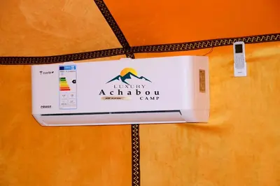a box of laundry academy camp is hanging on a wall at Sahara Luxury Camp - Nuit de rêve dans le désert de Merzouga ! in Merzouga