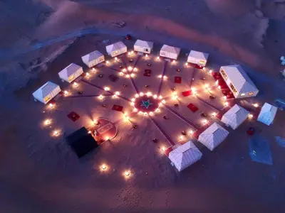 an overhead view of a container yard at night with lights at Sahara Luxury Camp - Nuit de rêve dans le désert de Merzouga ! in Merzouga