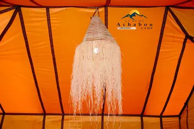 a white object hanging from the ceiling of a tent at Sahara Luxury Camp - Nuit de rêve dans le désert de Merzouga ! in Merzouga