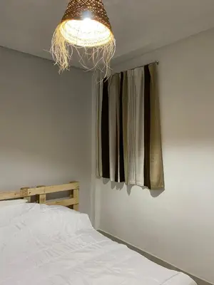 a bedroom with a bed and a light hanging from the ceiling at Appart propre et bien situé d in Fès