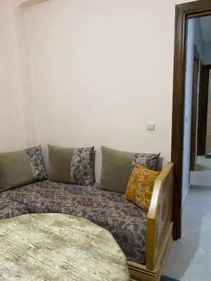 a couch with pillows sitting in a living room at Appart propre et bien situé d in Fès