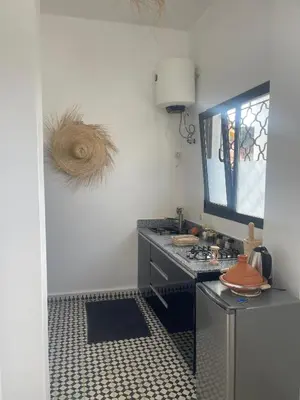 a kitchen with a counter and a sink in a room at Studio Yasmine in Azrou