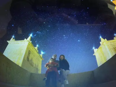 two women and a child sitting on top of a building at Kasbah Titrit & Spa in Aït Ben Haddou