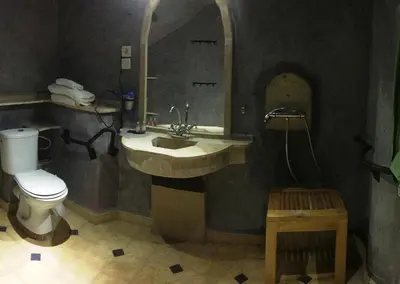 a bathroom with a sink and a toilet and a mirror at Kasbah Titrit & Spa in Aït Ben Haddou