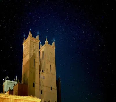 a tall building at night with the stars in the sky at Kasbah Titrit & Spa in Aït Ben Haddou