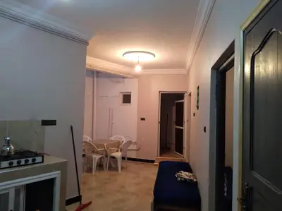 a living room with a fireplace and a table and chairs at Appartement centre ville de Tinghir in Tinerhir