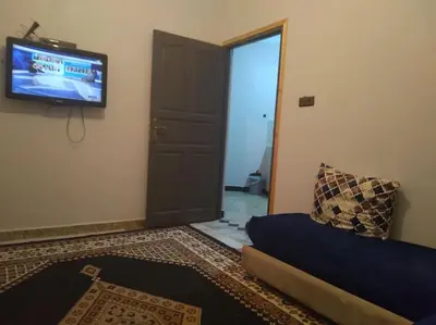 a living room with a couch and a television at Appartement centre ville de Tinghir in Tinerhir