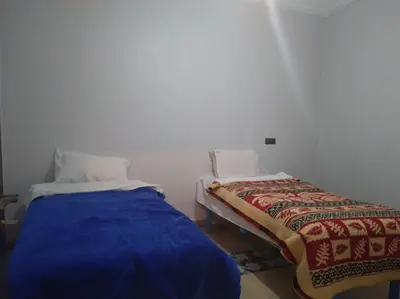 a room with two beds in a room at Appartement centre ville de Tinghir in Tinerhir