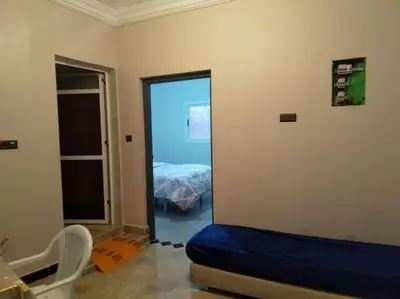 a room with a bedroom with a bed and a mirror at Appartement centre ville de Tinghir in Tinerhir