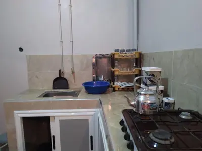 a kitchen with a stove with a tea kettle on it at Appartement centre ville de Tinghir in Tinerhir