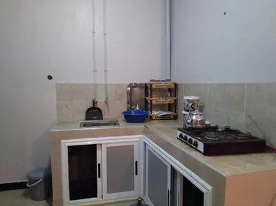 a kitchen with a stove and a counter top at Appartement centre ville de Tinghir in Tinerhir