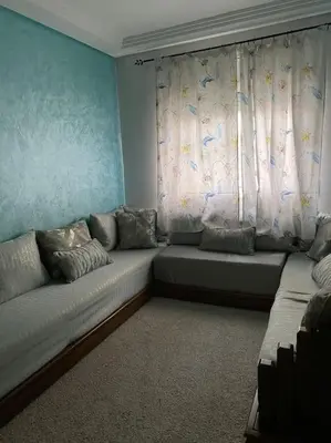 a living room with a couch and a window at Appart propre et bien situé in Fès