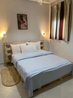a bedroom with a large bed with blue sheets and pillows at Appart propre et bien situé in Fès