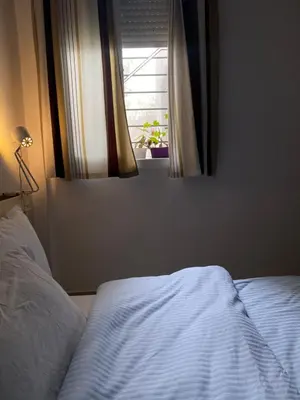 a bedroom with a white bed and a window at Appart propre et bien situé in Fès