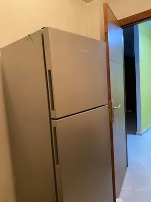 a stainless steel refrigerator in a kitchen with an open door at Appart propre et bien situé in Fès