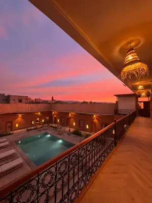 a view from the balcony of a house with a swimming pool at Rose Garden Dades in Kalaat MGouna