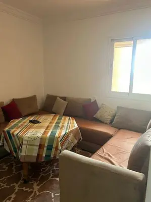 a living room with a couch with a blanket on it at iliy House in Mrhila