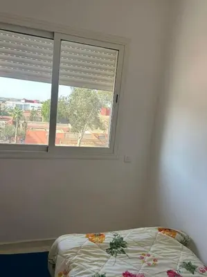a bedroom with a window and a bed in front of it at iliy House in Mrhila