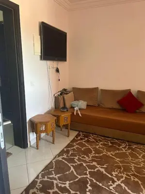 a living room with a couch and a flat screen tv at iliy House in Mrhila
