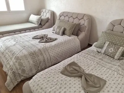 a bedroom with two beds and a couch at My HOME in Tinerhir