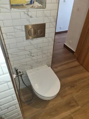 a bathroom with a white toilet in a stall at My HOME in Tinerhir