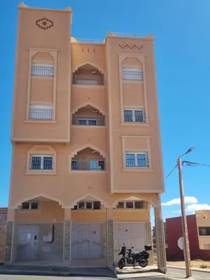 a building with a motorcycle parked in front of it at My HOME in Tinerhir