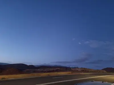 an empty road in the middle of the desert at My HOME in Tinerhir