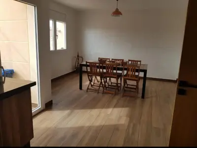 a dining room with a table and chairs at My HOME in Tinerhir
