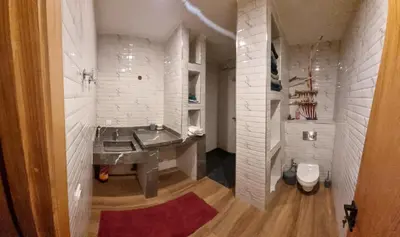a bathroom with a large sink and white brick walls at My HOME in Tinerhir