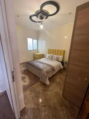 a bedroom with a bed and a ceiling fan at حي الزهراء in Khenifra