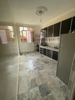 a kitchen with a tile floor and a counter top at حي الزهراء in Khenifra
