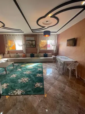 a living room with a couch and a table at حي الزهراء in Khenifra