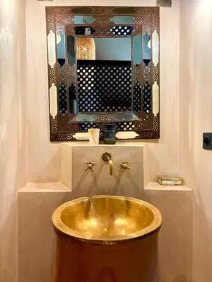 a bathroom with a gold sink and a mirror at Palais Danka in Sraïri