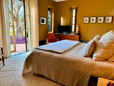 a bedroom with a large bed and a television at Palais Danka in Sraïri
